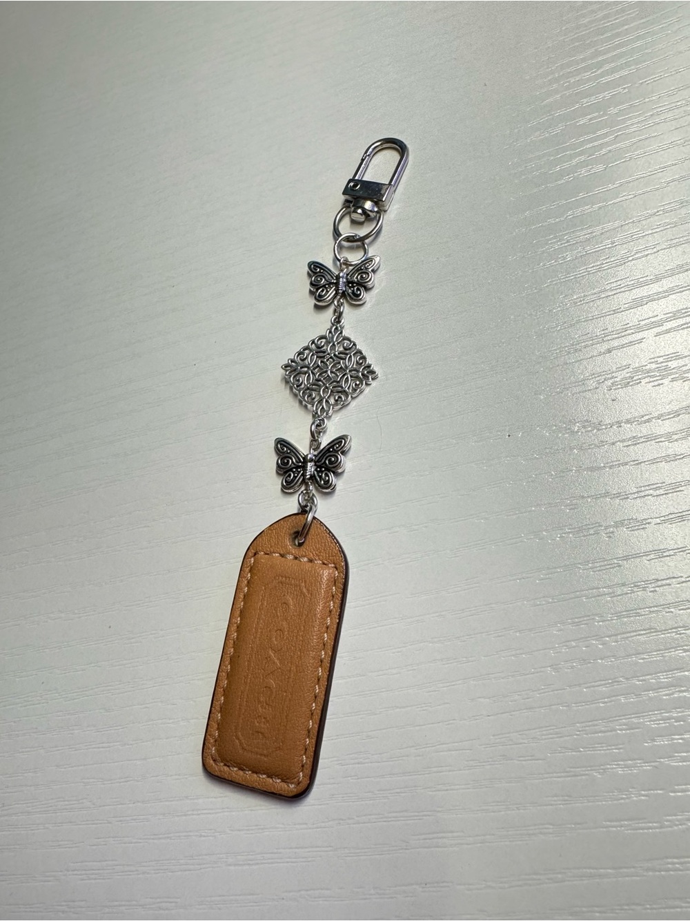 COACH Brown Leather Hangtag Butterfly Charm Keychain - Picture 2 of 3